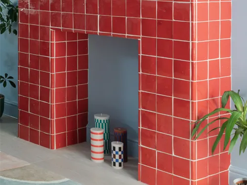 Decorative fireplace with red zellige tiles